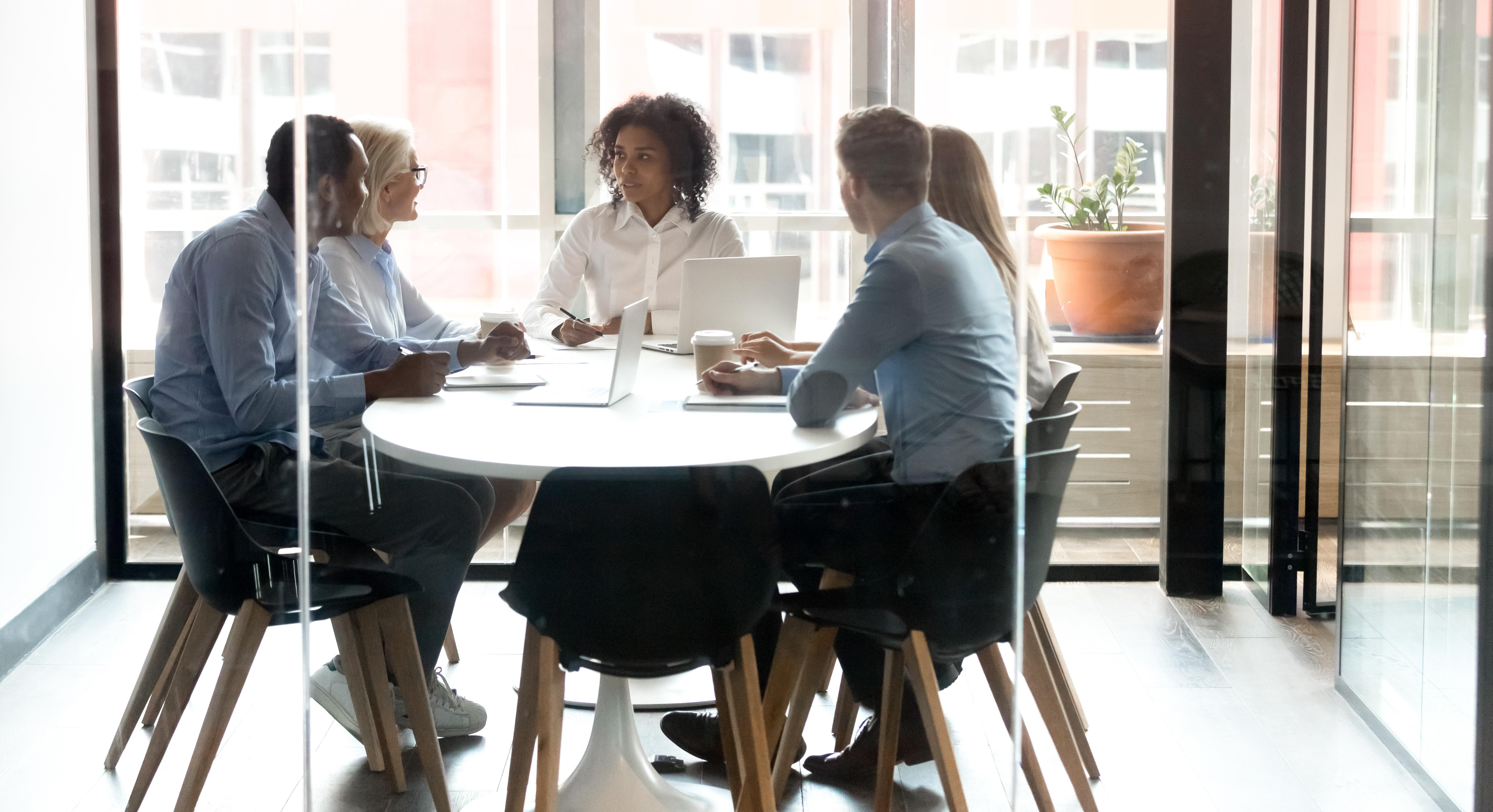 people sitting around a table talking